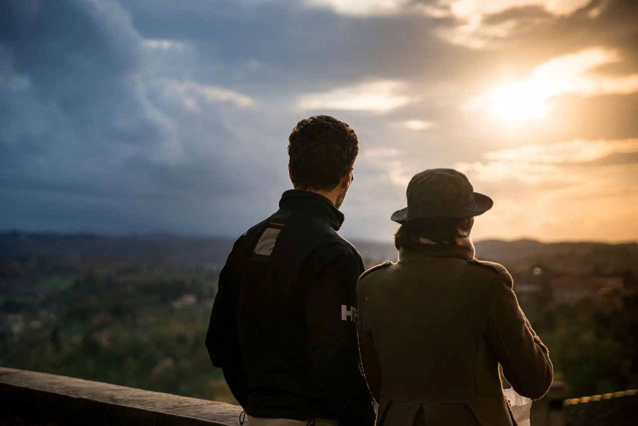A couple admiring the sunset over the rolling hills of San Miniato a charming town in Tuscany known for its scenic landscapes